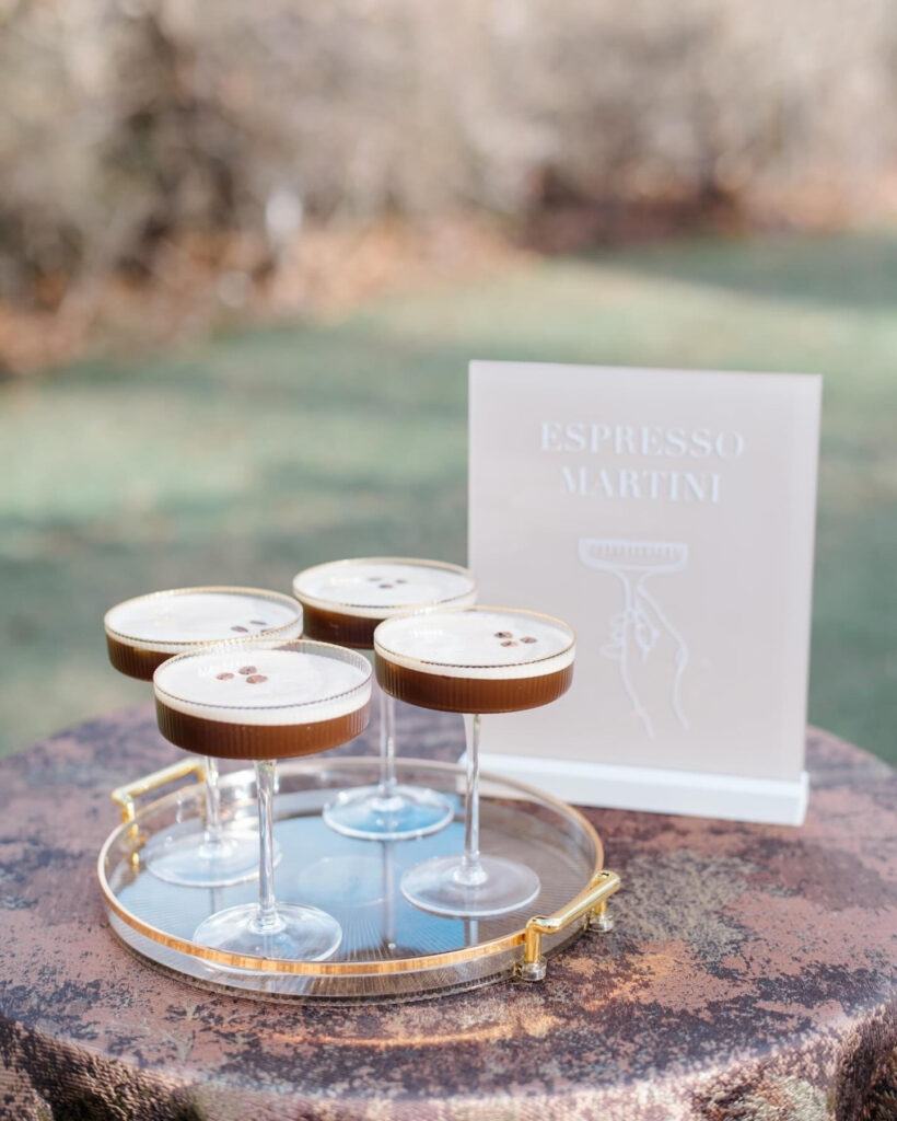 Espresso martinis served on a tray with modern signage.