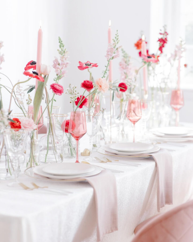 Elegant spring wedding table with pink flowers and glassware, highlighting the best time of year to get married.