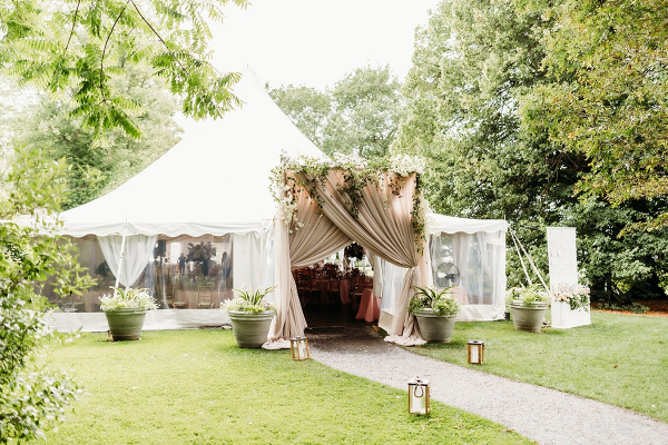 Romantic tented setup surrounded by greenery at one of the best intimate wedding venues in Rhode Island.