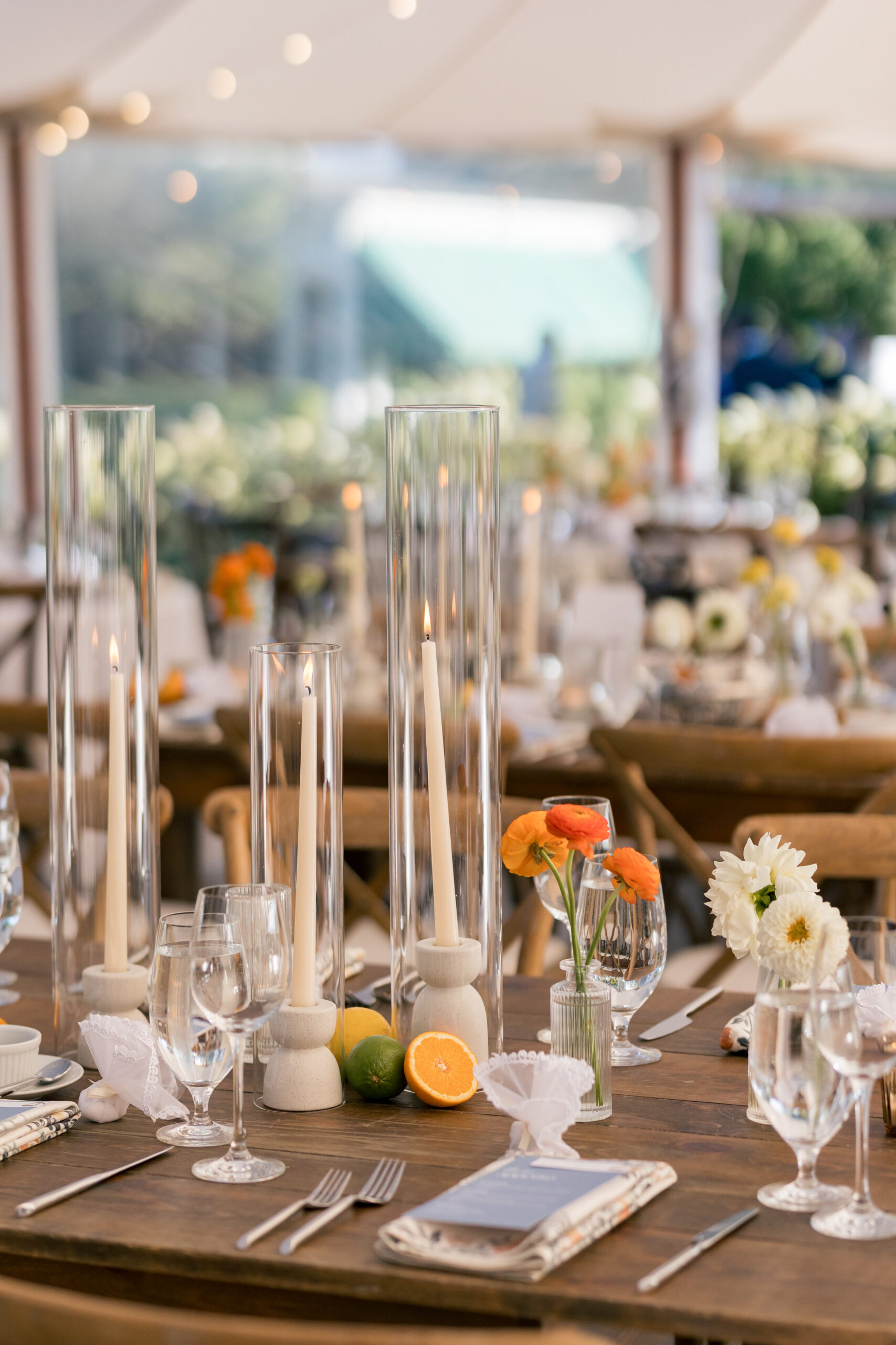 Elegant tablescape with tall candles, citrus accents, and bright florals reflecting fresh 2026 Wedding Design Trends