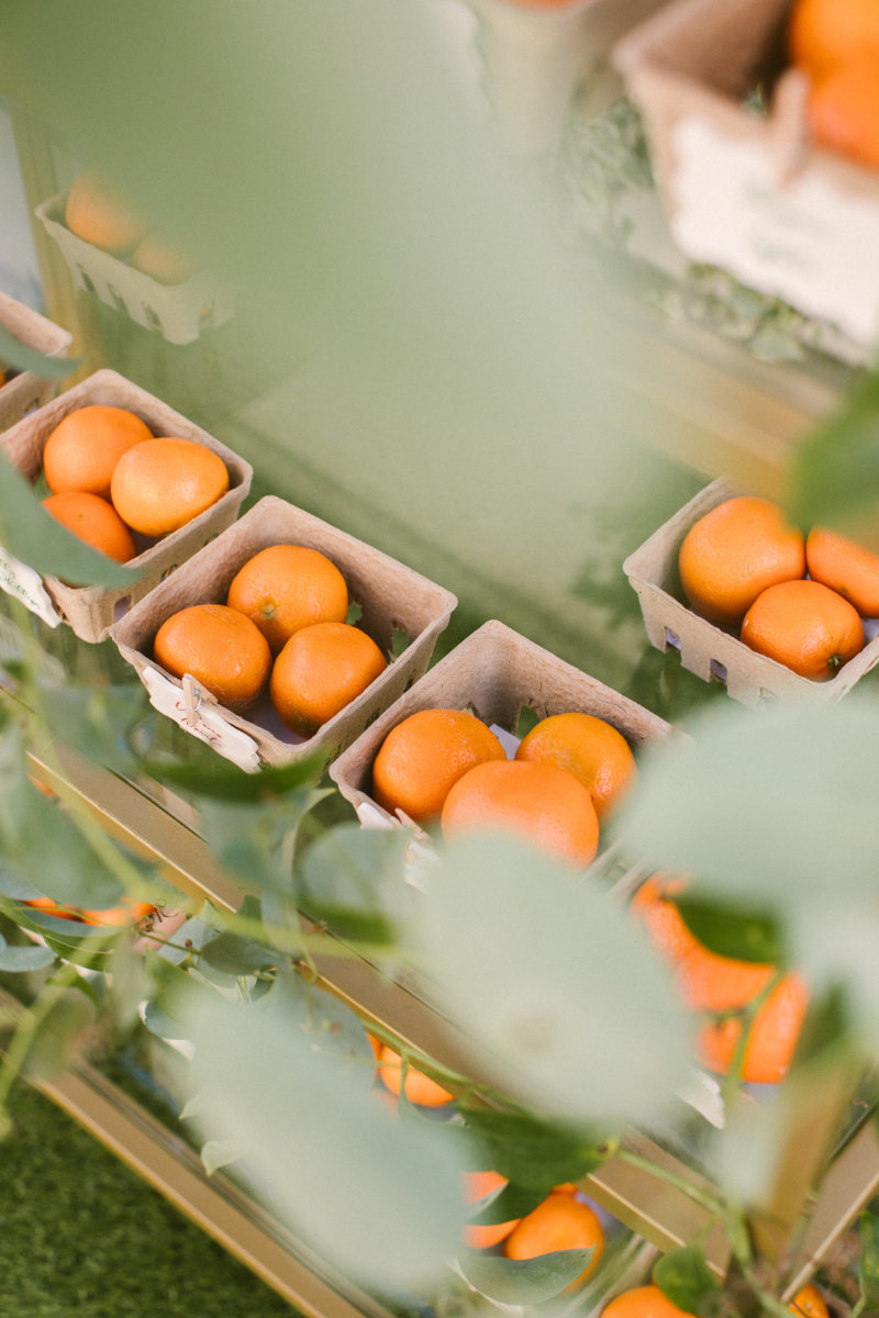 Mini crates of fresh citrus used as favors, a vibrant way to infuse Italian culinary culture.