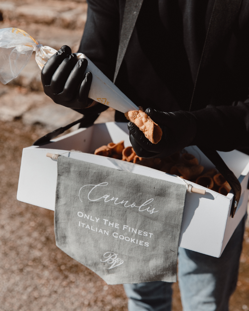 Fresh cannoli being filled on-site, a delicious way to infuse Italian culinary culture into dessert.
