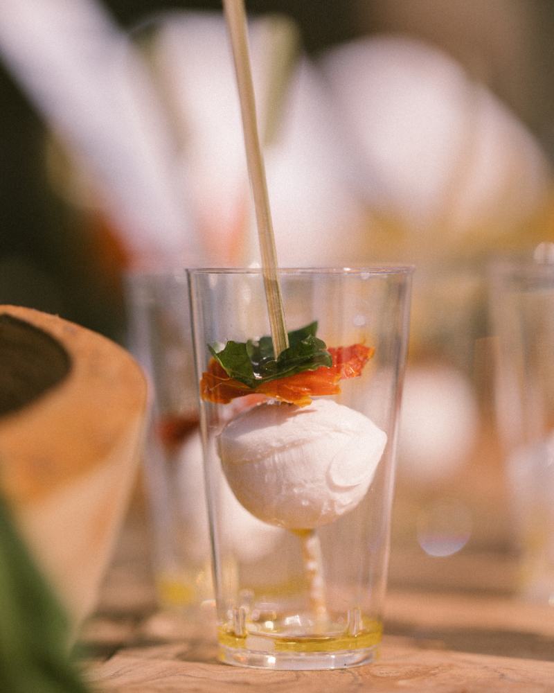 Fresh mozzarella, tomato, and basil served in a tasting glass to infuse Italian culinary culture.
