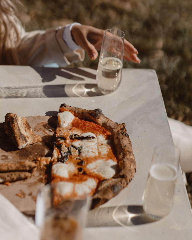 Wood-fired Margherita pizza and prosecco, a relaxed way to infuse Italian culinary culture.