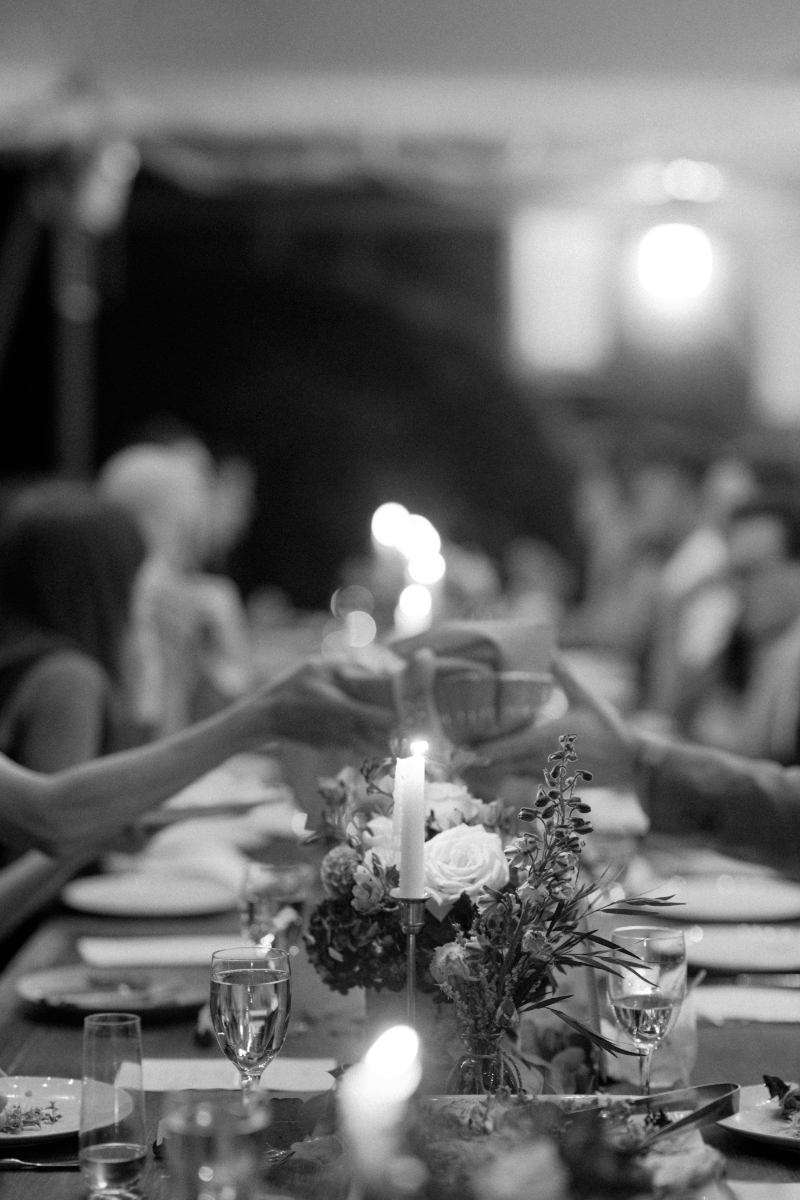 Elegant candlelit dinner table with guests toasting, capturing how shared meals infuse Italian culinary culture.