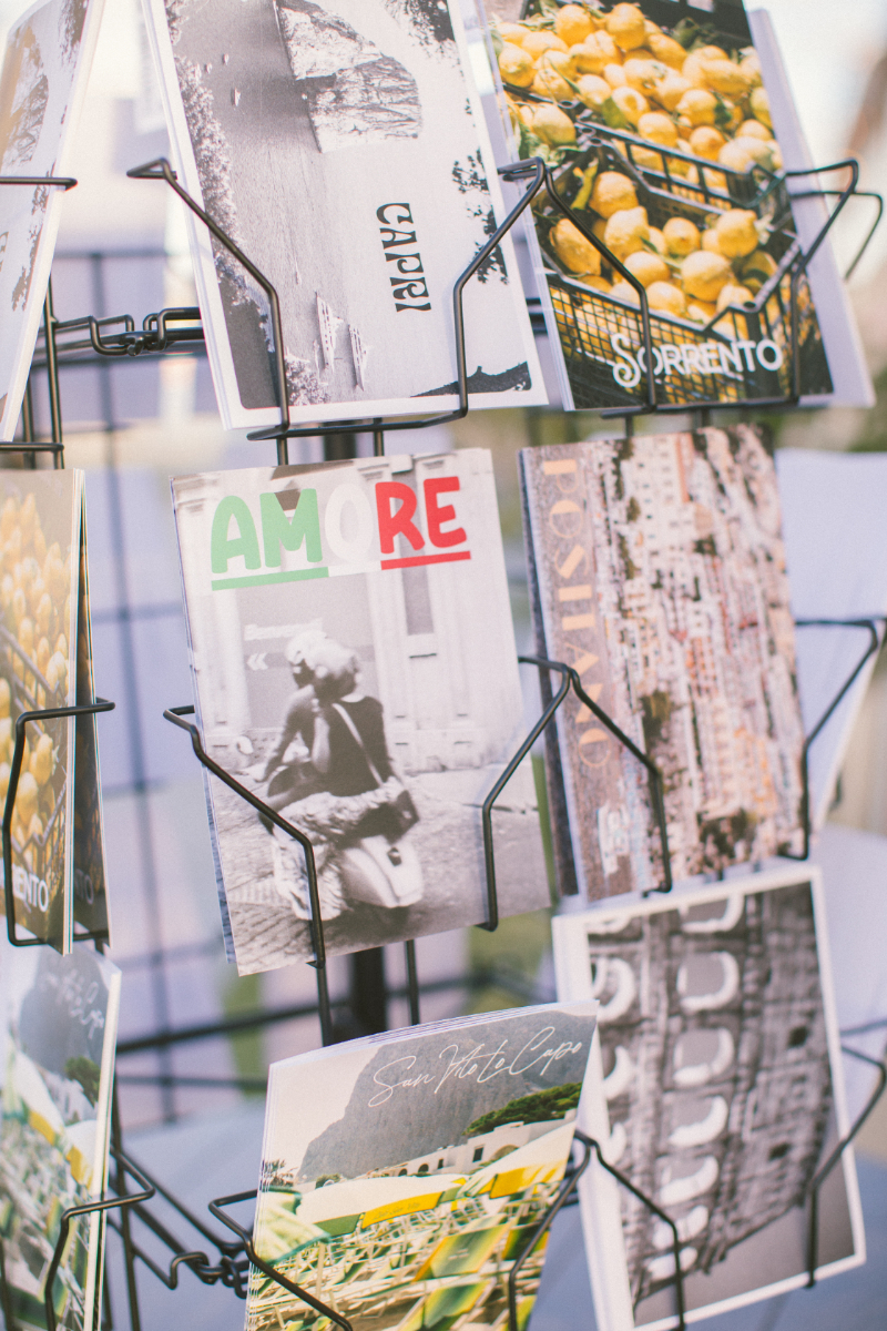Vintage-style Italian postcards on display, a charming detail to infuse Italian culinary culture.