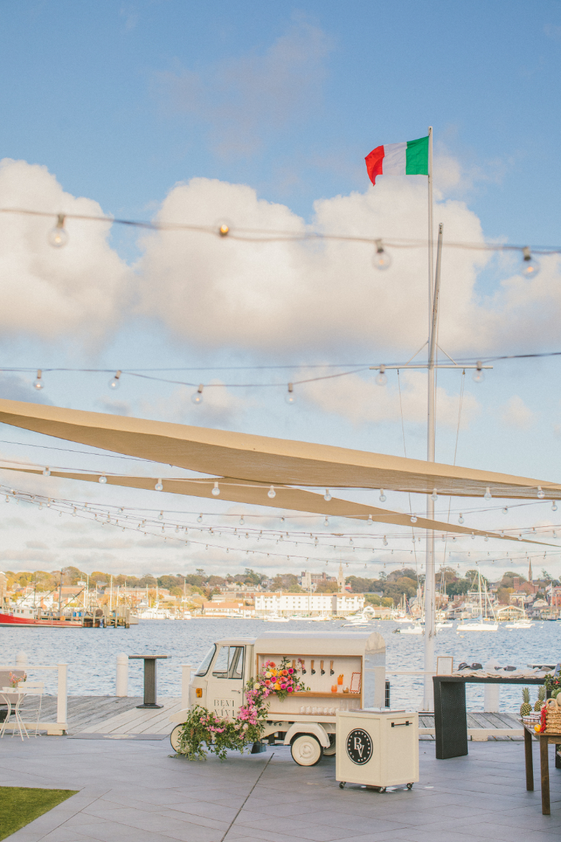 Chic waterfront wedding bar cart setup, a stylish way to infuse Italian culinary culture into drinks.
