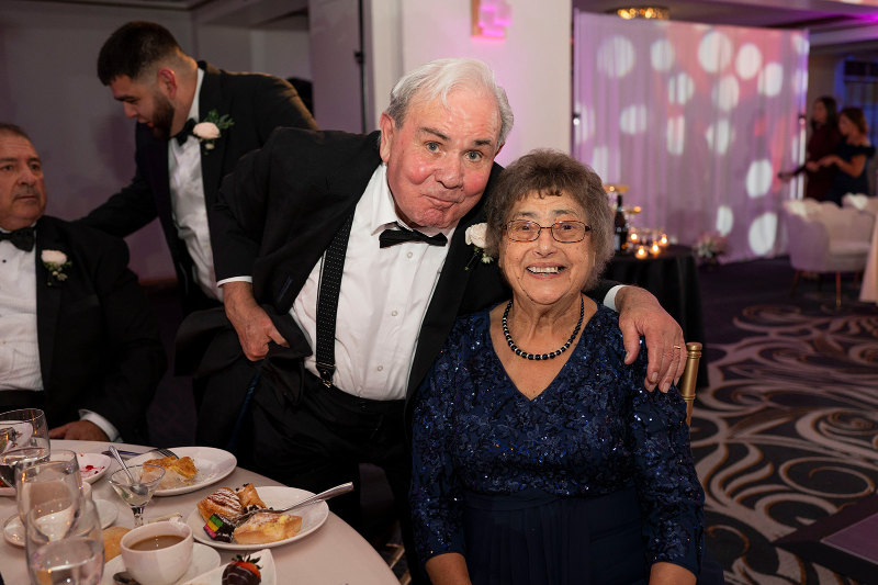 Older wedding guests enjoying dessert and connection, highlighting the importance of creating an inclusive wedding experience.