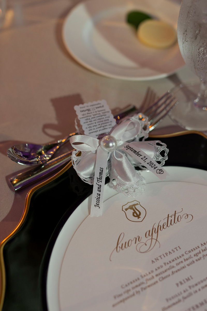 Elegant Italian-inspired place setting designed for creating an inclusive wedding experience, featuring custom menu details.