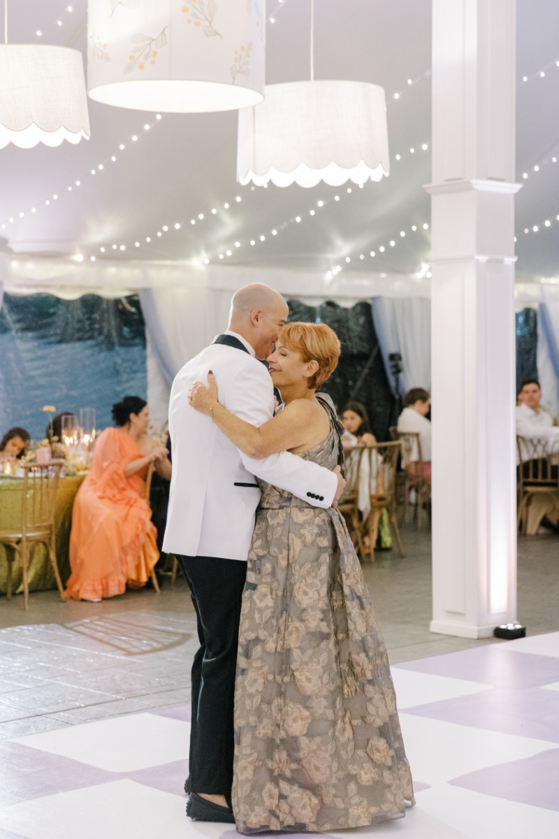 Father and bride sharing emotional dance under string lights inside reception tent at a Blithewold Mansion wedding