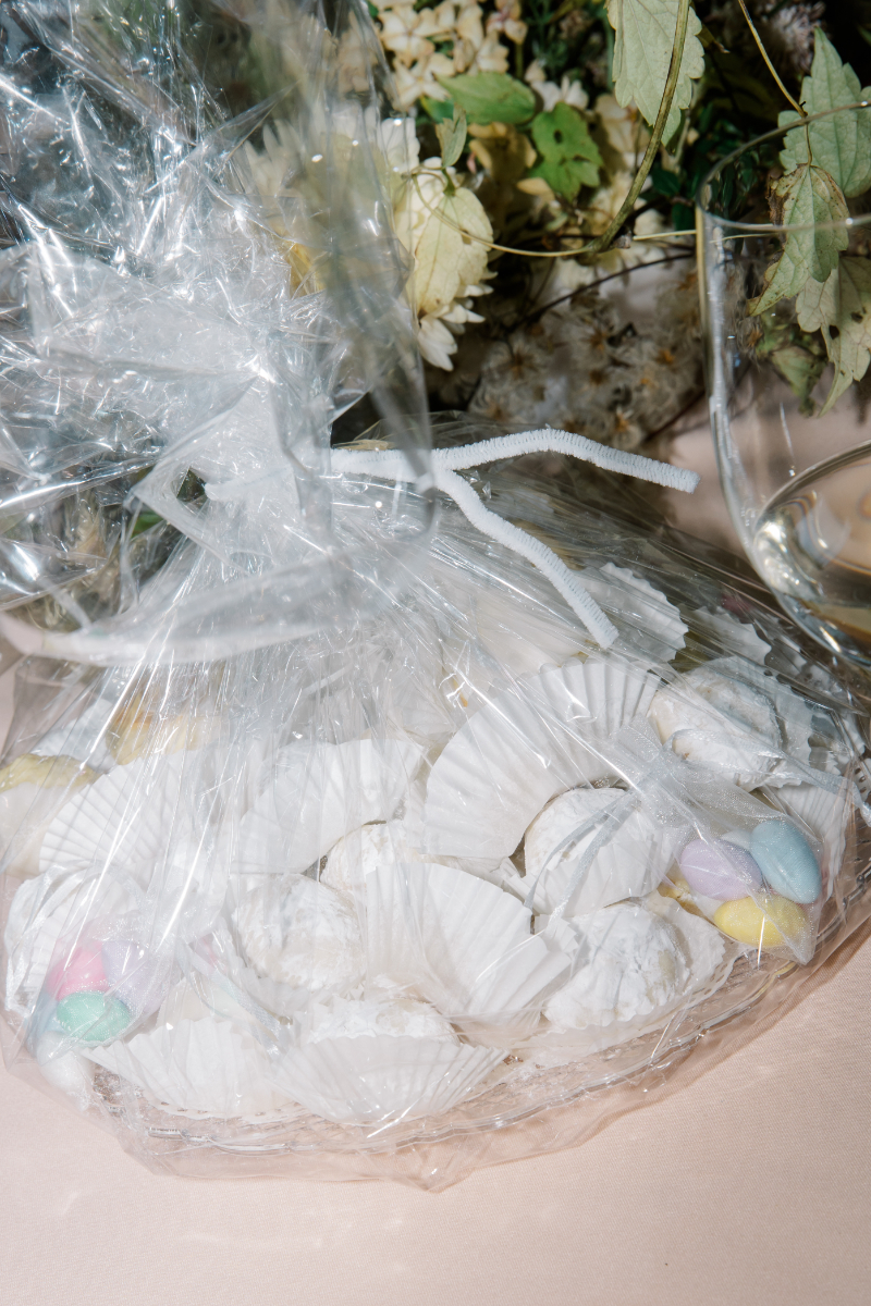Bagged Italian wedding cookies wrapped in clear cellophane on display table at a Blithewold Mansion wedding 