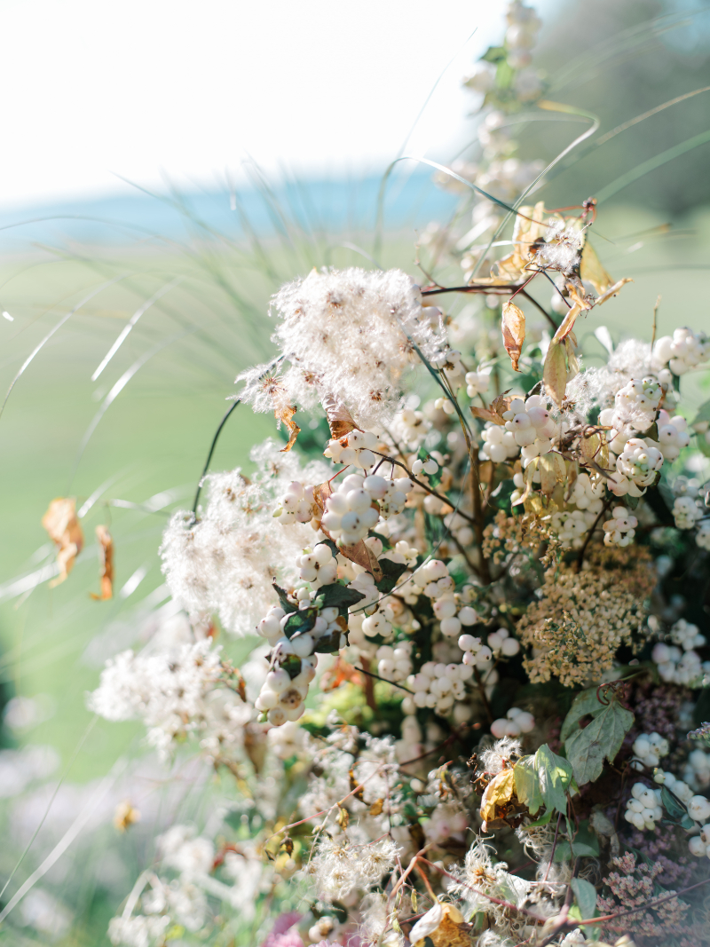 Blithewold Mansion wedding ceremony florals with soft white blooms and greenery.