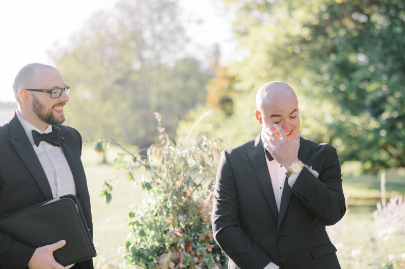 Blithewold Mansion wedding groom reacting emotionally during outdoor ceremony.