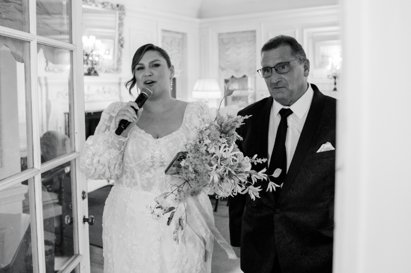 Blithewold Mansion wedding bride giving speech with bouquet beside father.