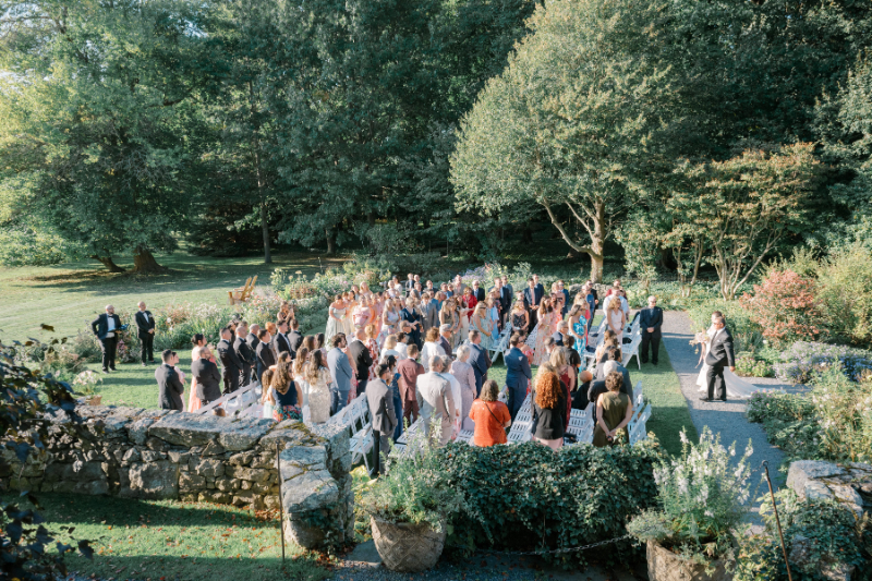 Blithewold Mansion wedding outdoor ceremony with guests seated in garden setting.