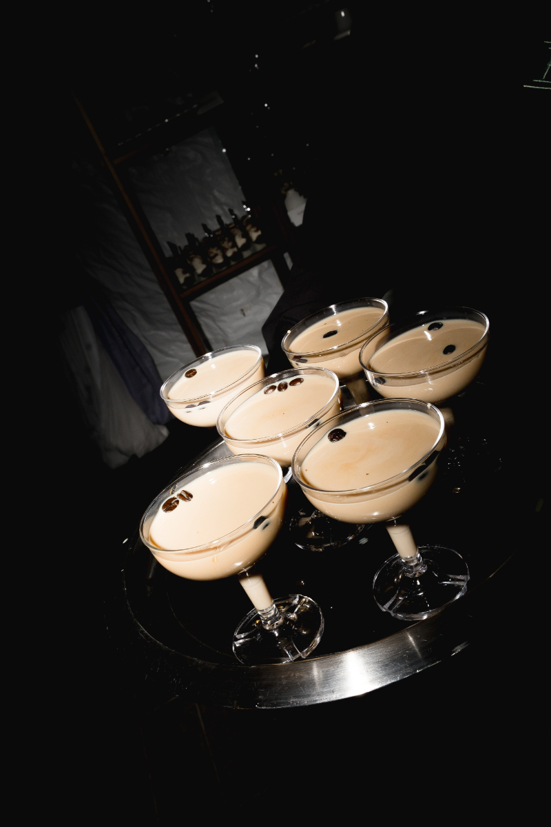 Espresso martinis served in coupe glasses on black cocktail tray at a Blithewold Mansion wedding 