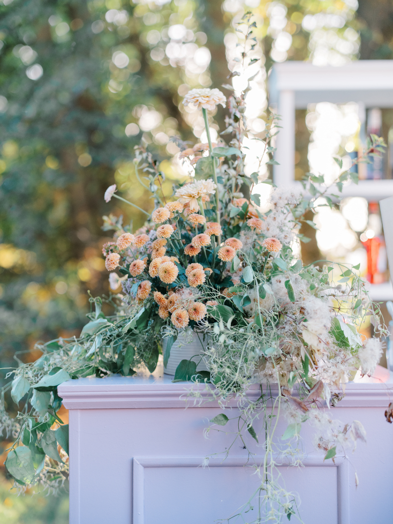 Blithewold Mansion wedding floral installation with soft peach blooms and cascading greenery.