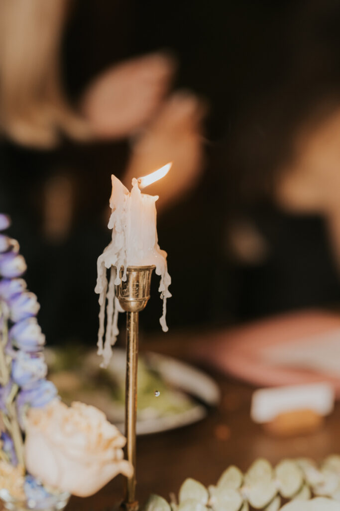 Dripping candle detail on reception table at Italian countryside wedding.