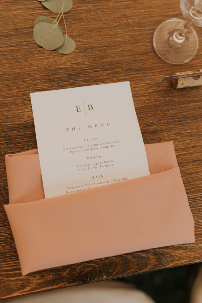 Menu and place setting detail at Italian countryside wedding dinner.