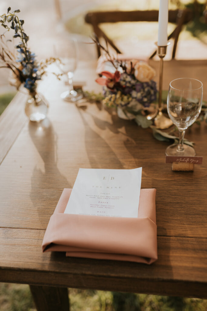 Menu and blush napkin place setting at Italian wedding reception.