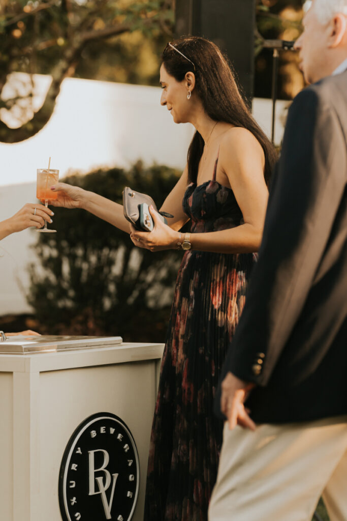 Guest receiving cocktail during Italian countryside wedding cocktail hour.