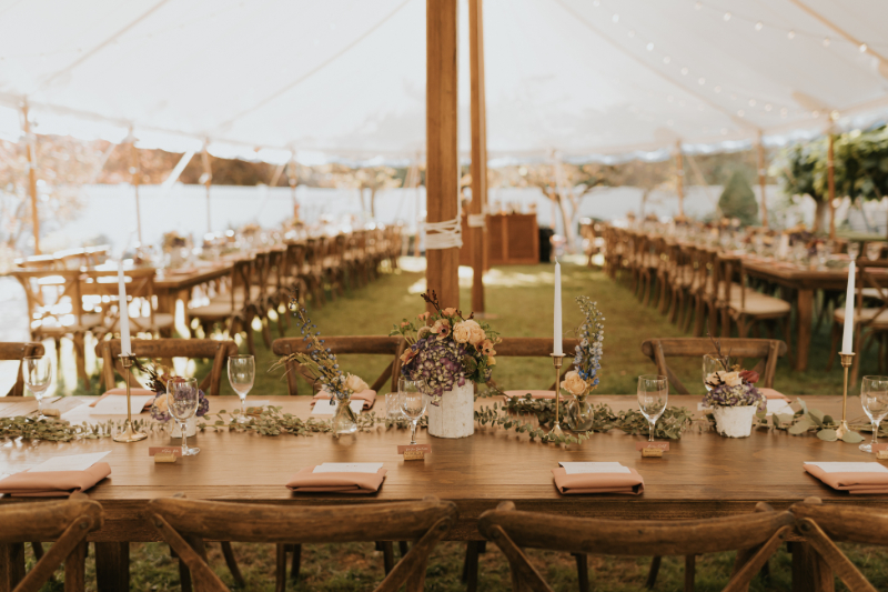 Head table floral centerpiece at Italian wedding under tent.