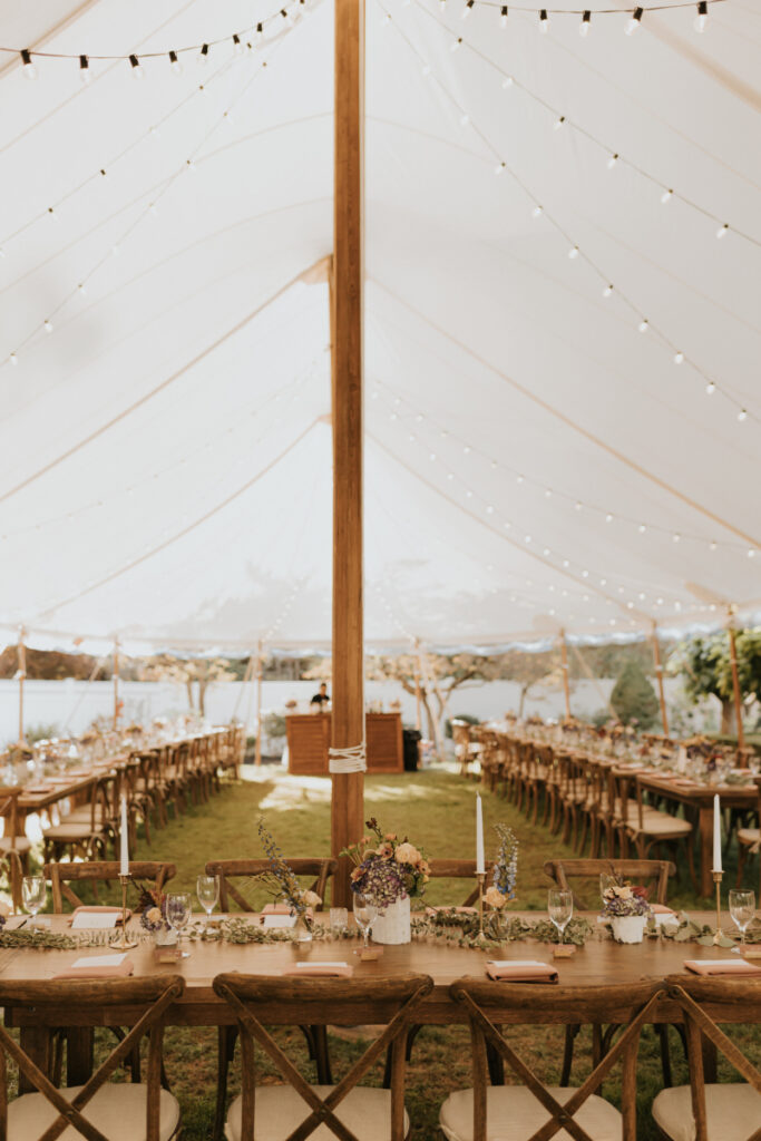 Wide view of tented dinner setup at an Italian wedding