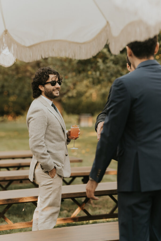 Guests greeting each other during Italian countryside wedding cocktail hour.