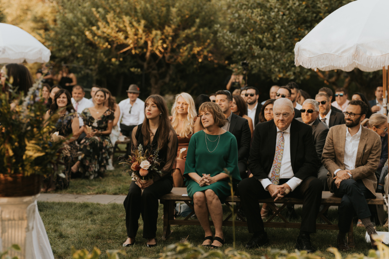 Guests seated outdoors during Italian countryside wedding ceremony.