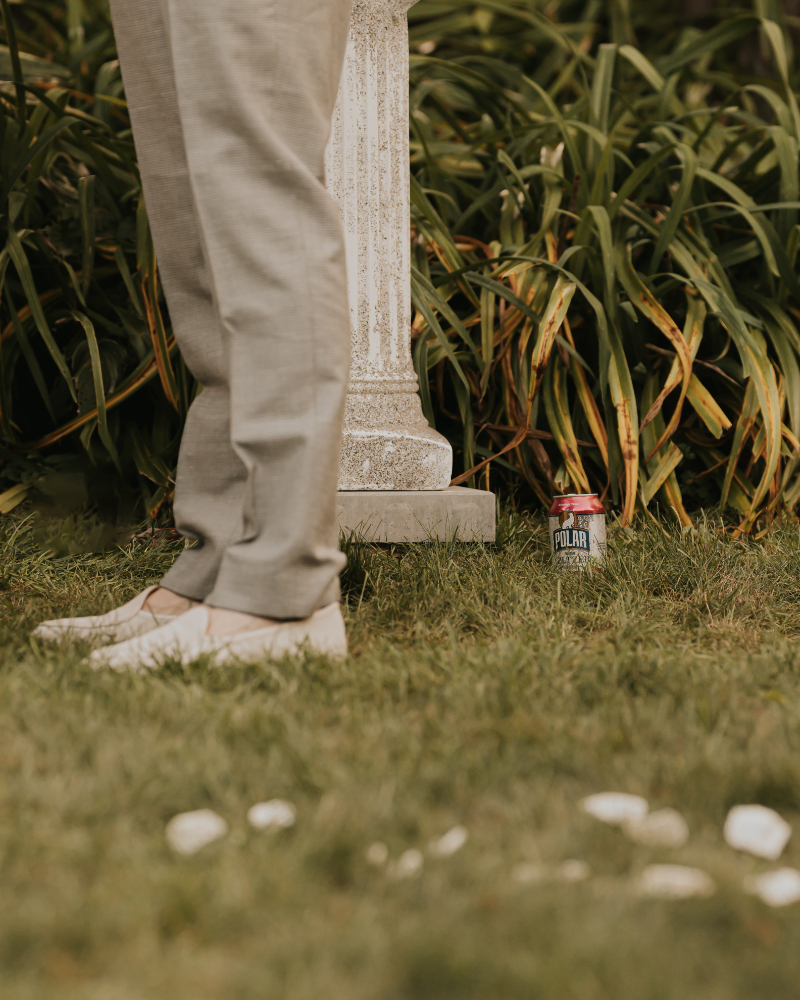 Bride reading vows to groom during Italian countryside wedding ceremony.