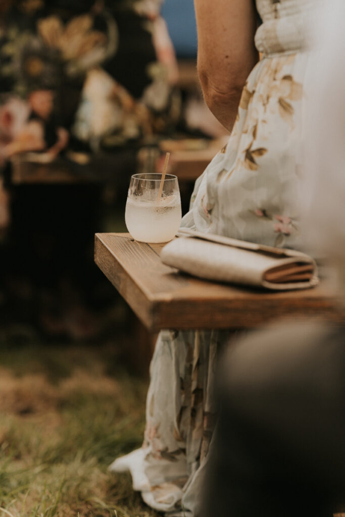 Cocktail detail on wooden table during Italian countryside wedding reception.
