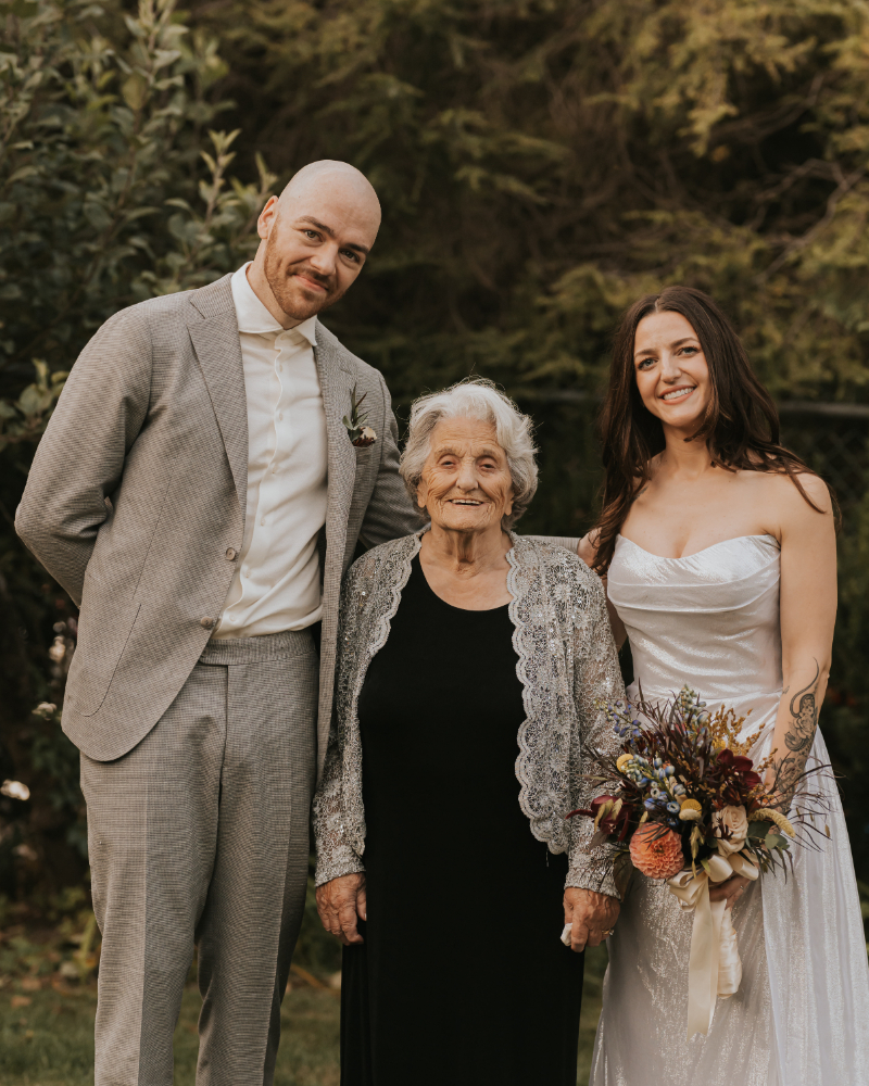 Bride and groom with grandmother at Italian countryside wedding family estate.