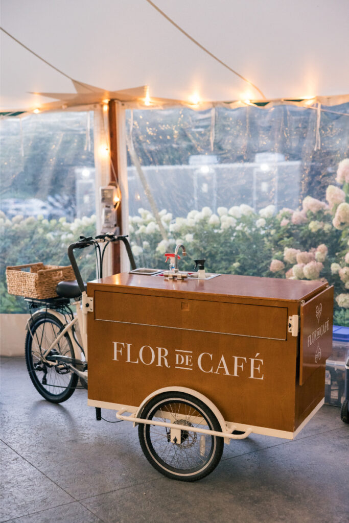 Slices of lemon cake garnished with florals and citrus on patterned linen.