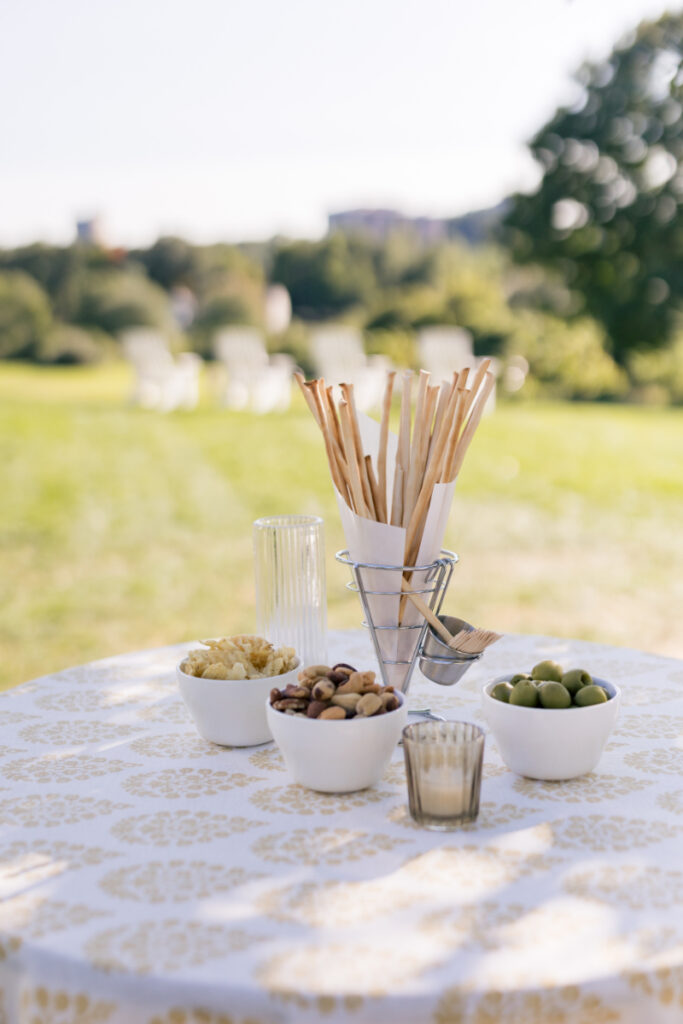 Outdoor cocktail table with Italian snacks and grissini at a wedding at Connemara House.