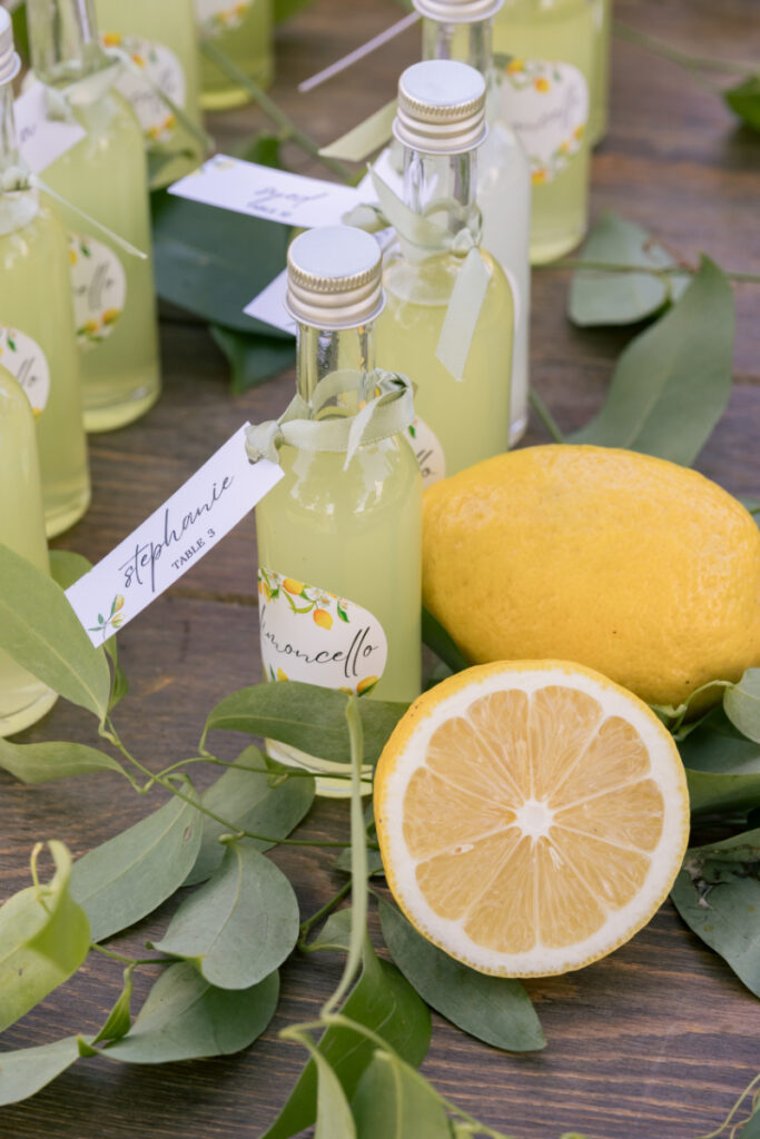 Limoncello escort cards with lemons and greenery for a personalized wedding at Connemara House.
