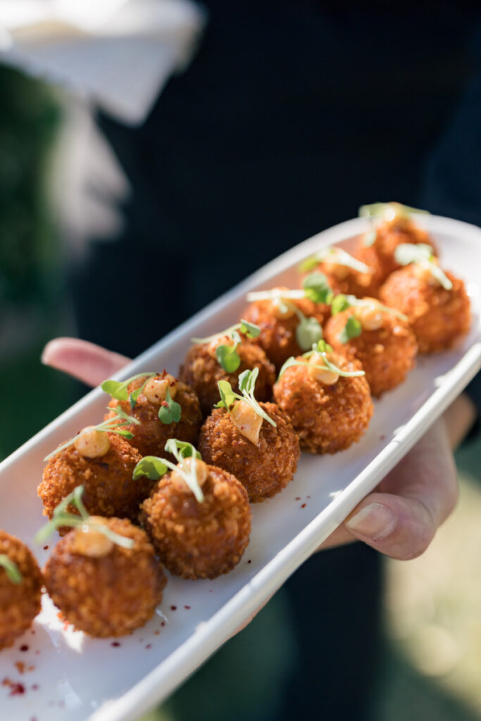 Citrus-infused water station with custom signage at a summer wedding at Connemara House.