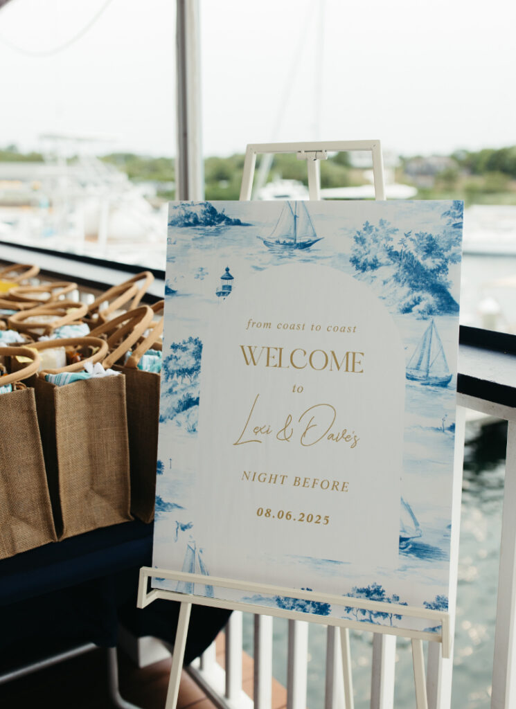 Welcome sign for wedding weekend overlooking harbor during coastal Block Island wedding celebration.