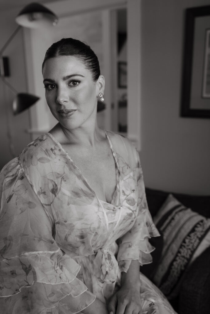 Bride portrait in floral robe during quiet getting-ready moments before the wedding ceremony.