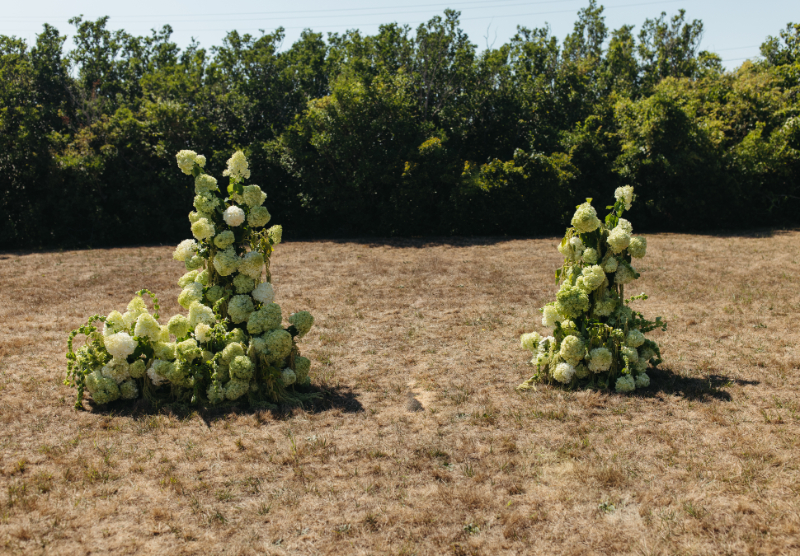 Hydrangea floral aisle arrangements marking ceremony space for romantic outdoor Block Island wedding.