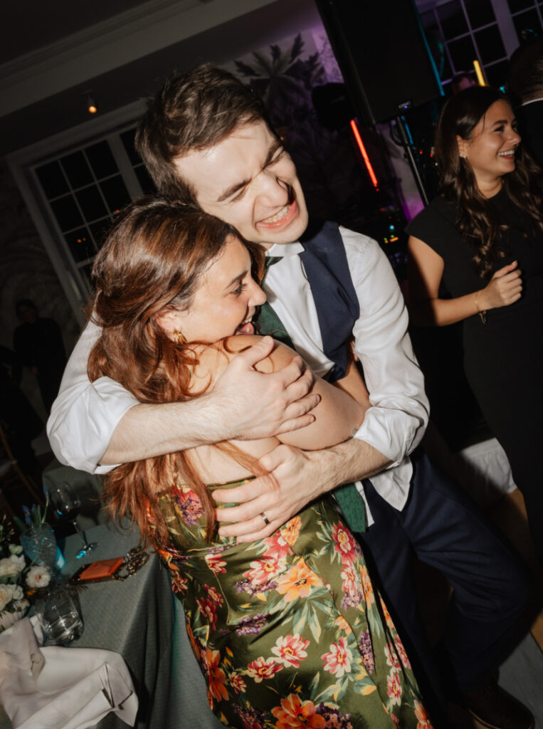 Guest hugging and dancing with another guest on the dance floor