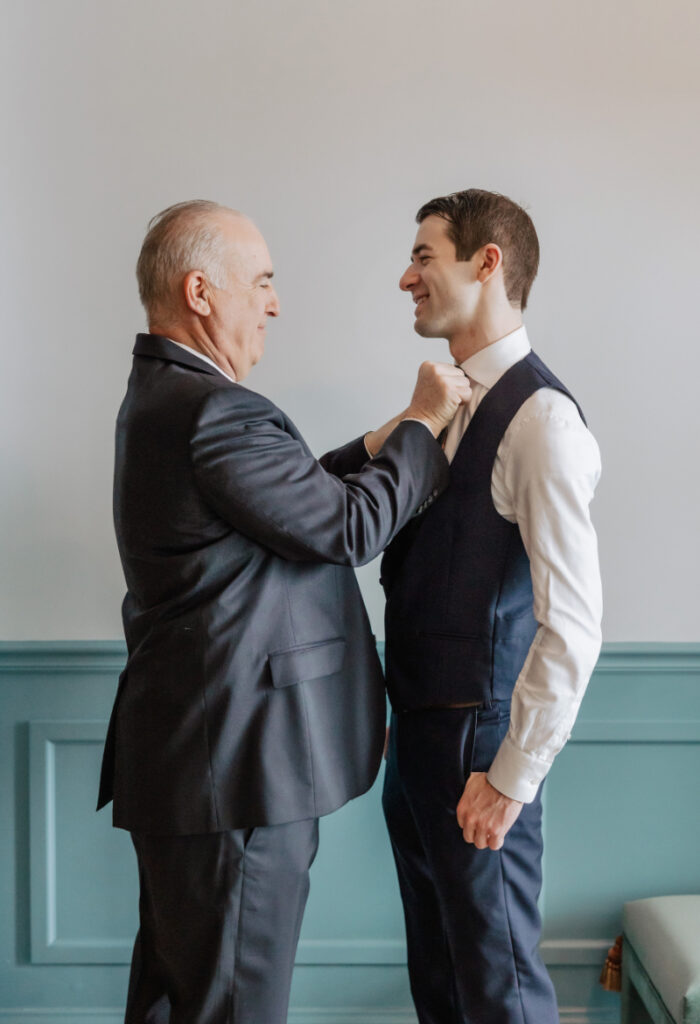 Groom getting ready with father adjusting tie, meaningful Newport wedding morning moment