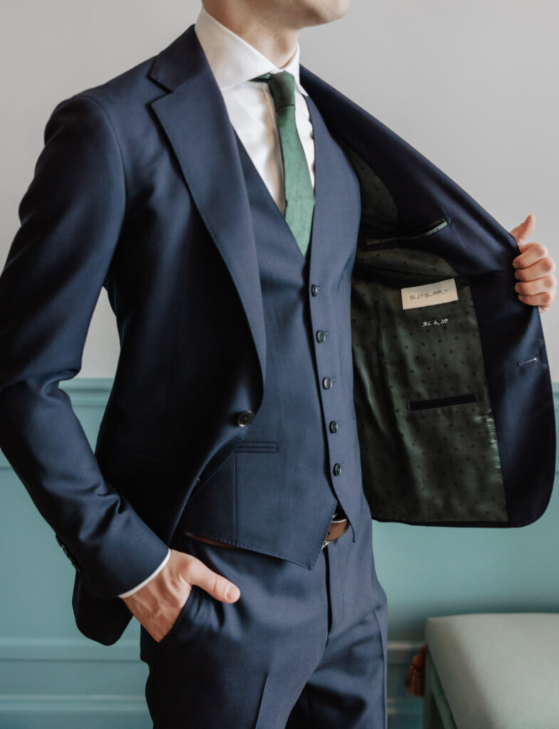 Close-up of groom’s navy suit and green tie, tailored Newport wedding style detail