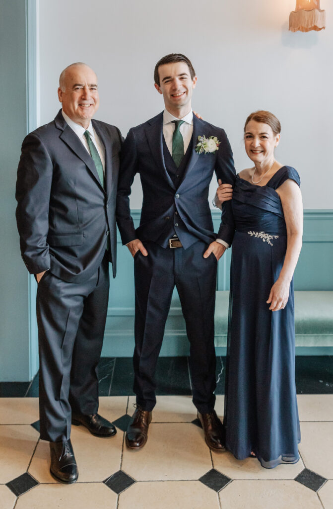 Groom with parents in navy attire, classic portraits during elegant Newport wedding morning preparations