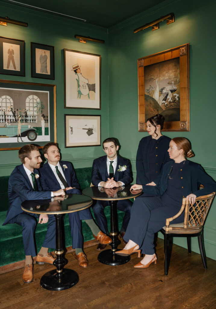 Wedding party gathered in green lounge, stylish pre-ceremony moment inside Newport wedding venue