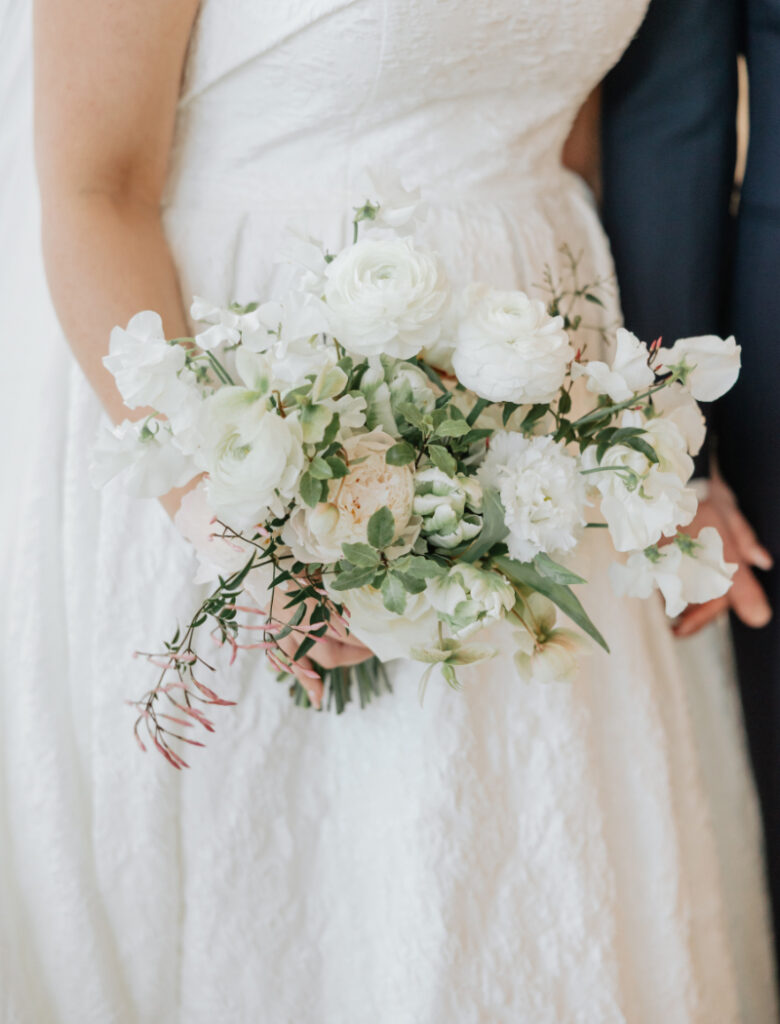Bride and groom smiling together indoors, soft natural light portrait at Newport wedding venue