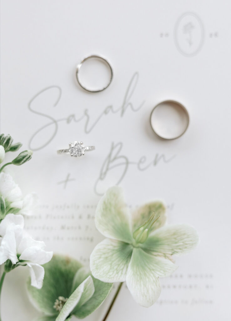 Wedding rings and invitation suite with soft florals, refined Newport wedding planner detail styling