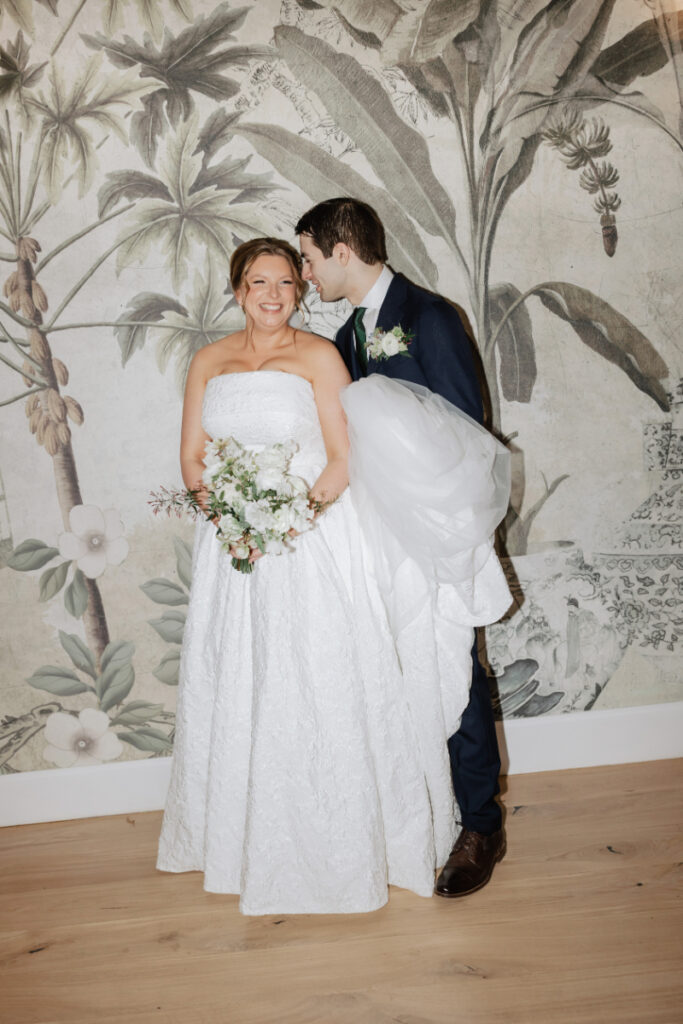 Bride and groom portrait against botanical mural backdrop, romantic Newport wedding planner design detail