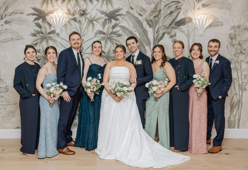 Wedding party group portrait with soft color palette, joyful moment during Newport wedding celebration