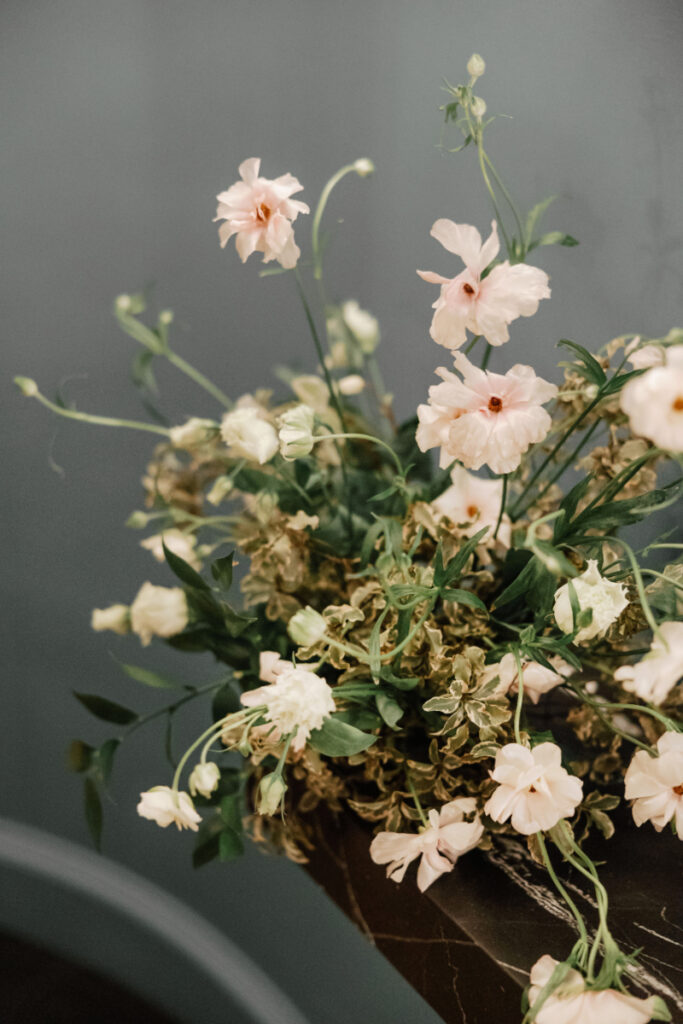Organic floral arrangement with soft neutral blooms and greenery, adding a natural, textural touch to the space