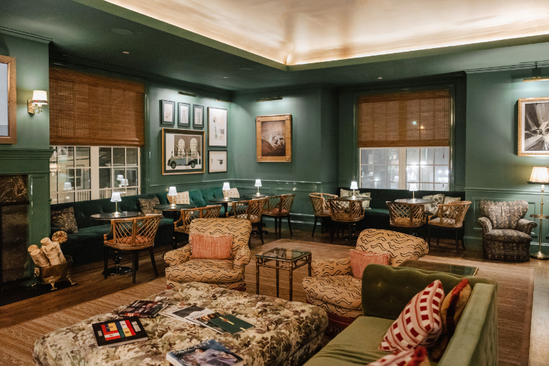 Moody lounge space with layered textures and curated artwork, creating an intimate and inviting cocktail hour setting